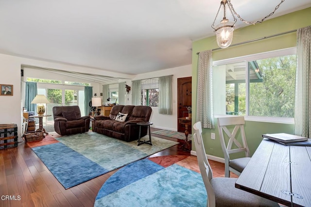 living area with wood finished floors and baseboards
