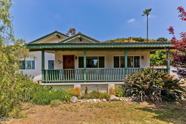 view of front facade featuring covered porch and stucco siding