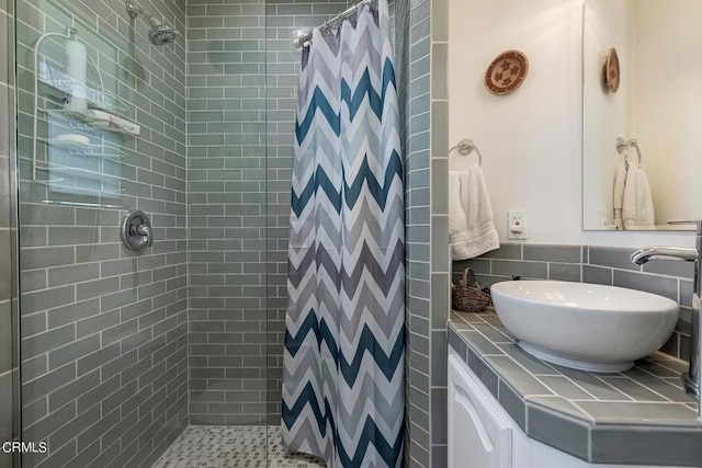 bathroom with a shower stall and vanity