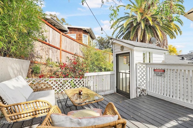wooden deck with an outbuilding