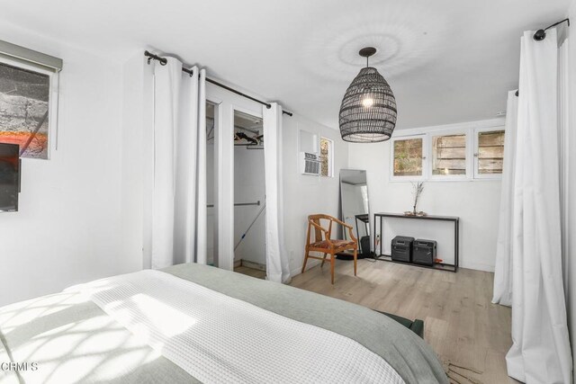 bedroom featuring baseboards and wood finished floors