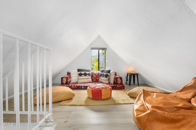 living room featuring wood finished floors and vaulted ceiling