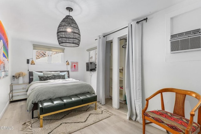 bedroom featuring baseboards and wood finished floors