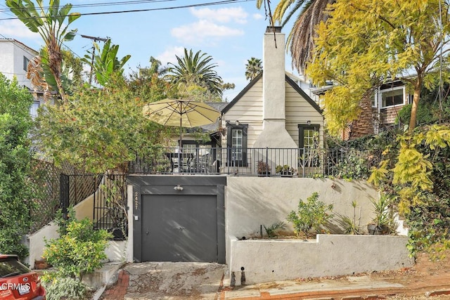 exterior space featuring fence and a chimney