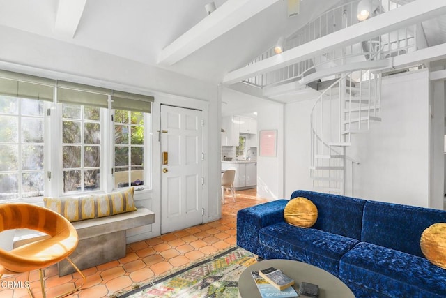 living area with stairway, vaulted ceiling, and light tile patterned flooring