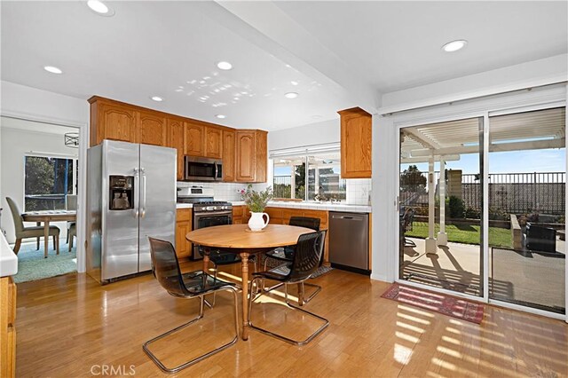 2332 Mccrea Rd, Thousand Oaks, CA 91362 - kitchen with stainless steel appliances, recessed lighting, light wood-style floors, backsplash, and light countertops