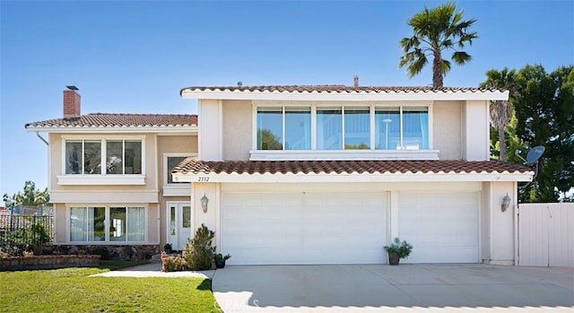 2332 Mccrea Rd, Thousand Oaks, CA 91362 - view of front of house with driveway, an attached garage, a chimney, a tile roof, and stucco siding
