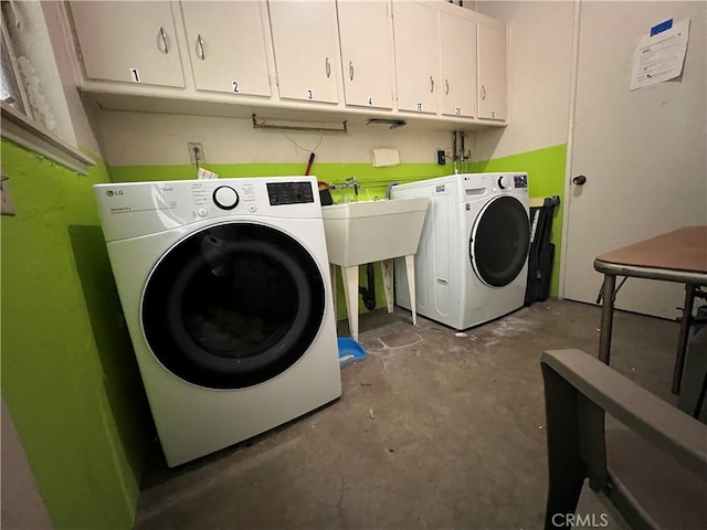 washroom with separate washer and dryer and cabinet space