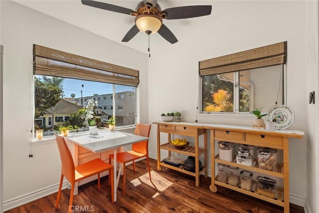 dining area featuring wood finished floors, baseboards, and ceiling fan