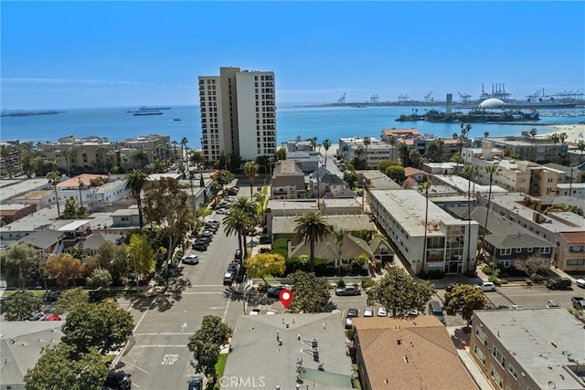 drone / aerial view featuring a city view and a water view