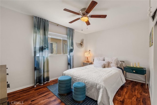 bedroom with baseboards, a ceiling fan, and wood finished floors