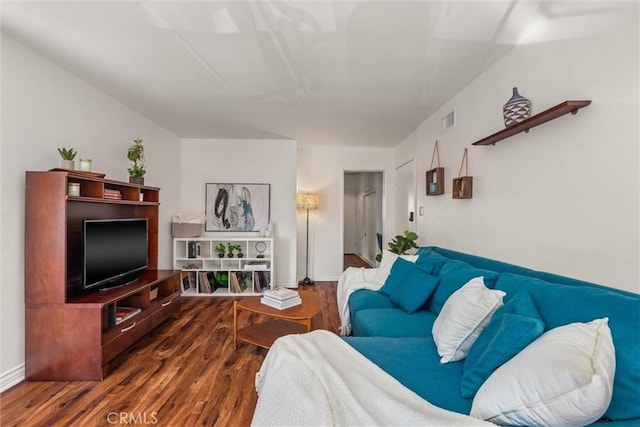 living room featuring baseboards, wood finished floors, and visible vents