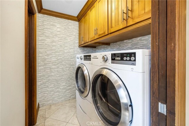 401 Holmwood Dr, Newport Beach, CA 92663 - laundry area featuring cabinet space, independent washer and dryer, light tile patterned floors, and crown molding