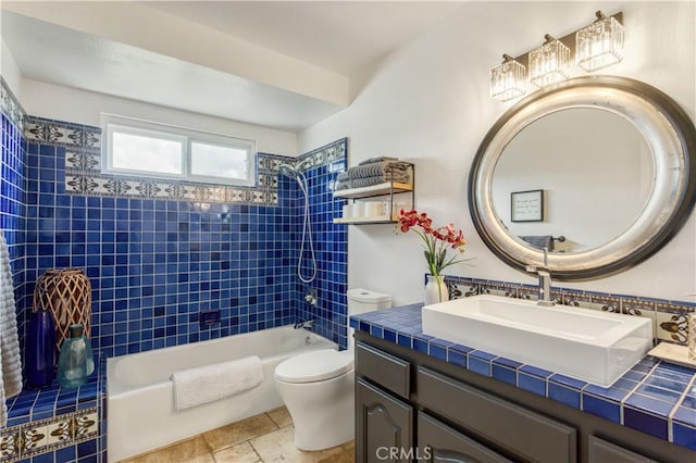 full bath featuring shower / bathing tub combination, stone tile flooring, toilet, and vanity