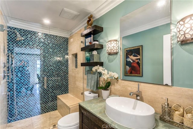 bathroom featuring a shower stall, vanity, crown molding, toilet, and visible vents