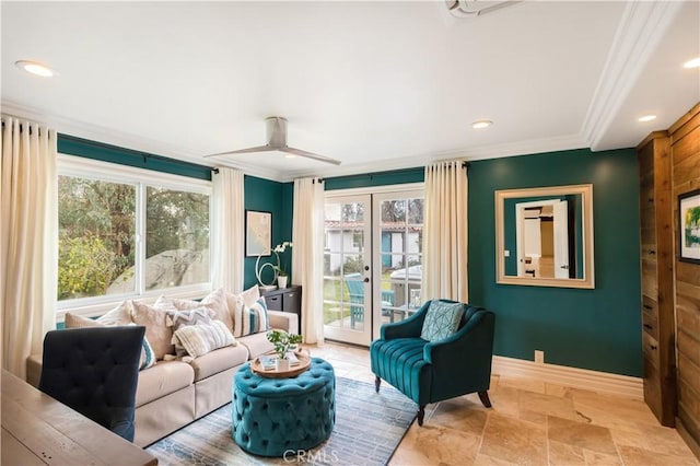living room featuring ornamental molding, recessed lighting, stone finish floor, and baseboards