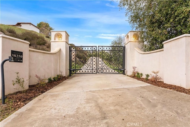view of gate featuring fence