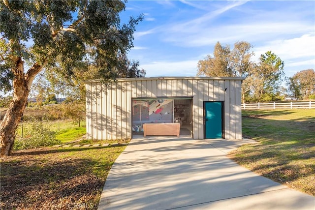 view of outbuilding with an outbuilding and fence