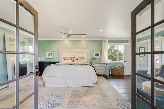 bedroom with wood finished floors and ornamental molding