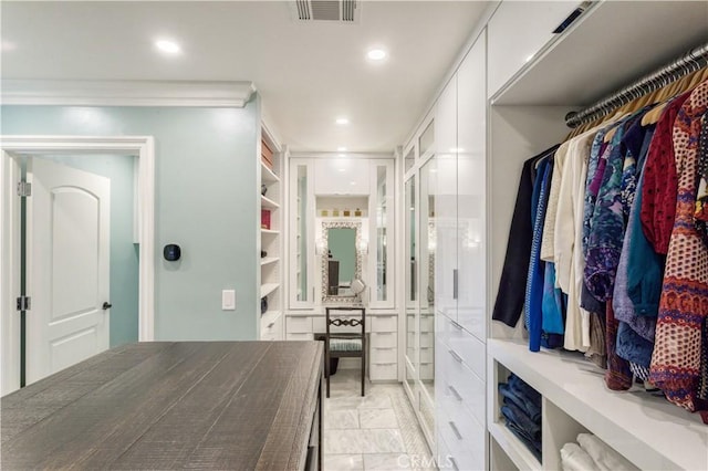 walk in closet with visible vents and marble finish floor