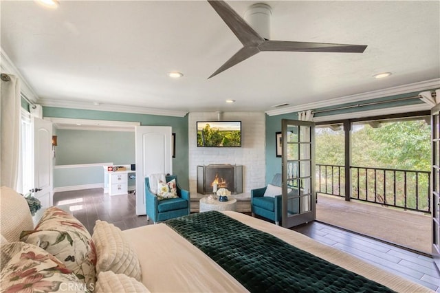 bedroom with a brick fireplace, access to outside, baseboards, ornamental molding, and wood finished floors