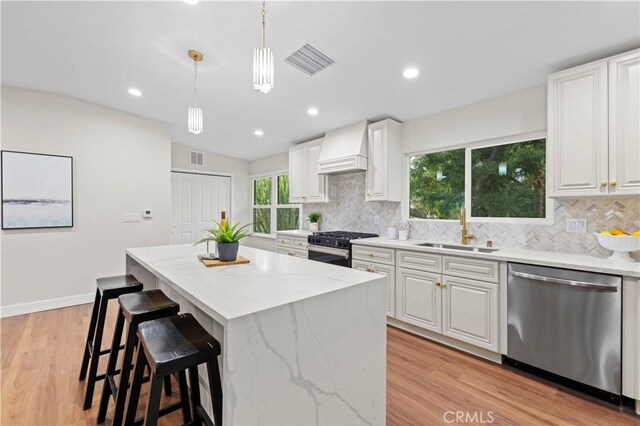 3476 Linda Vista Rd, Glendale, CA 91206 - kitchen featuring a sink, light stone counters, visible vents, appliances with stainless steel finishes, and custom exhaust hood