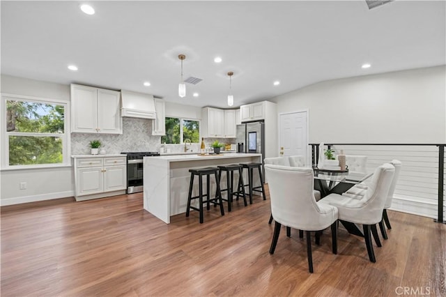 3476 Linda Vista Rd, Glendale, CA 91206 - dining space featuring visible vents, baseboards, recessed lighting, light wood-style floors, and vaulted ceiling