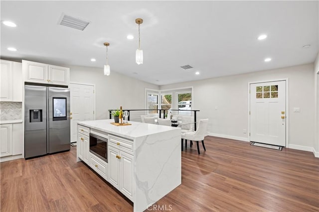 3476 Linda Vista Rd, Glendale, CA 91206 - kitchen with backsplash, white cabinets, wood finished floors, and appliances with stainless steel finishes