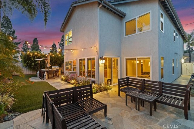 17 Ridgerock, Laguna Niguel, CA 92677 - back of house featuring an outdoor hangout area, a patio, stucco siding, and a fenced backyard