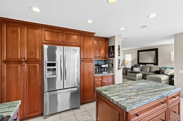 17 Ridgerock, Laguna Niguel, CA 92677 - kitchen with stainless steel fridge, light stone countertops, light tile patterned floors, recessed lighting, and brown cabinetry