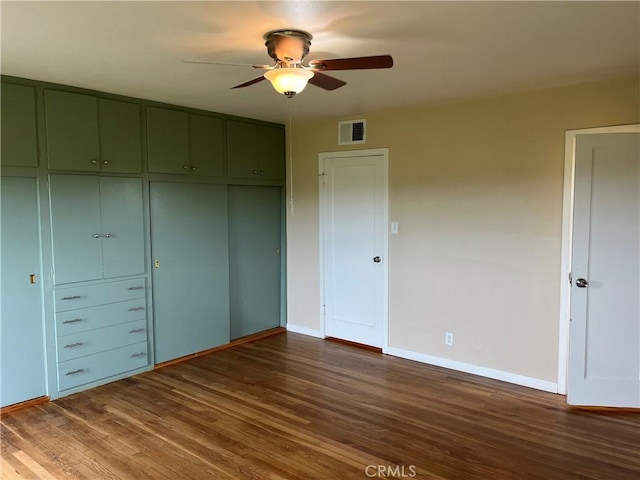11122 Schafer Ave, Los Molinos, CA 96055 - unfurnished bedroom with dark wood finished floors, baseboards, a closet, and ceiling fan