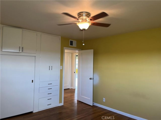 11122 Schafer Ave, Los Molinos, CA 96055 - unfurnished bedroom with baseboards, dark wood-style flooring, a closet, and a ceiling fan