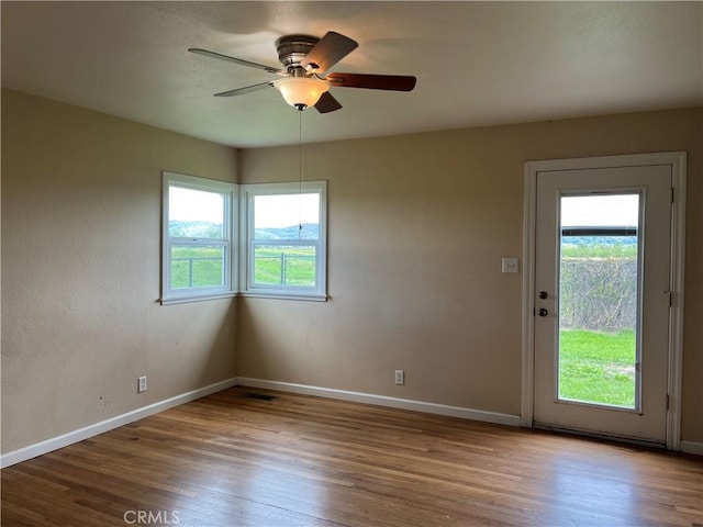 11122 Schafer Ave, Los Molinos, CA 96055 - unfurnished room with baseboards, wood finished floors, and a ceiling fan