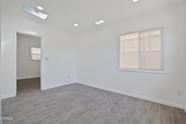 unfurnished room featuring visible vents, recessed lighting, baseboards, and wood finished floors