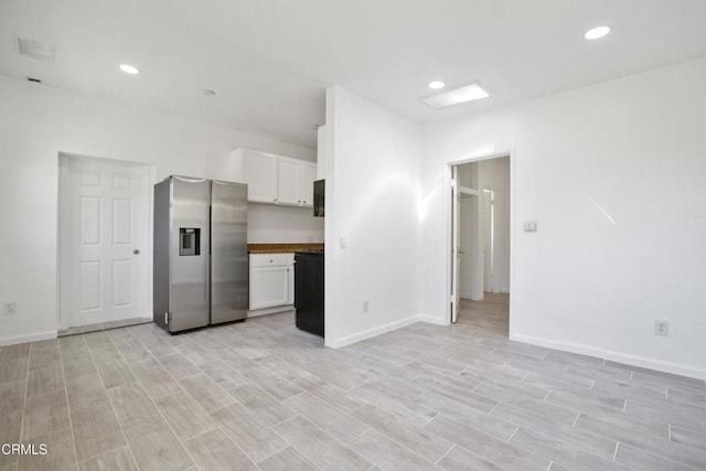 kitchen featuring recessed lighting, stainless steel fridge, white cabinets, and light wood-type flooring