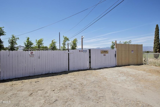 view of gate with fence