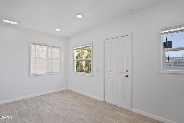 unfurnished room featuring light wood-style flooring, recessed lighting, baseboards, and visible vents