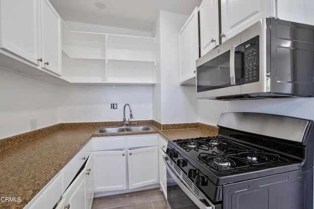 kitchen featuring a sink, white cabinetry, stainless steel appliances, and open shelves