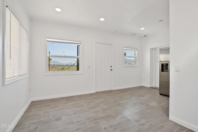 foyer entrance featuring plenty of natural light, recessed lighting, and baseboards