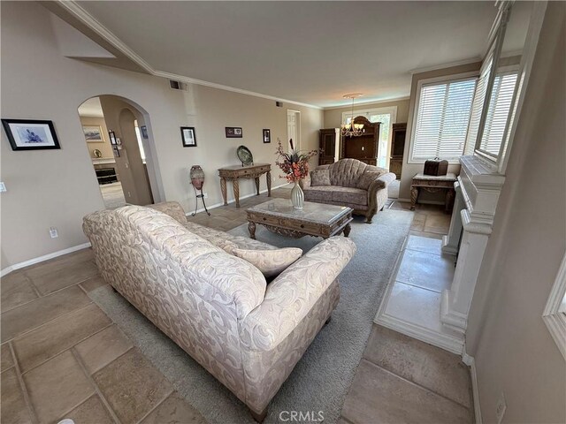 1050 Ginger Cir, Corona, CA 92879 - living room featuring arched walkways, baseboards, visible vents, and ornamental molding