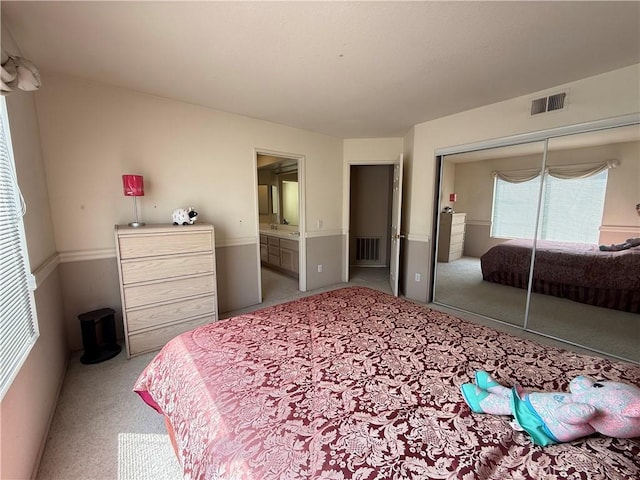 1050 Ginger Cir, Corona, CA 92879 - carpeted bedroom with visible vents, ensuite bathroom, and a closet