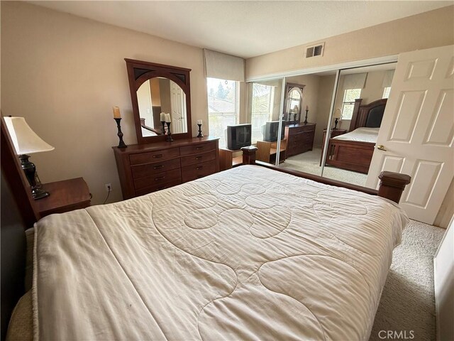 1050 Ginger Cir, Corona, CA 92879 - carpeted bedroom featuring visible vents and a closet