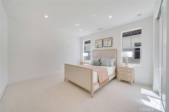 bedroom with light colored carpet, baseboards, and recessed lighting