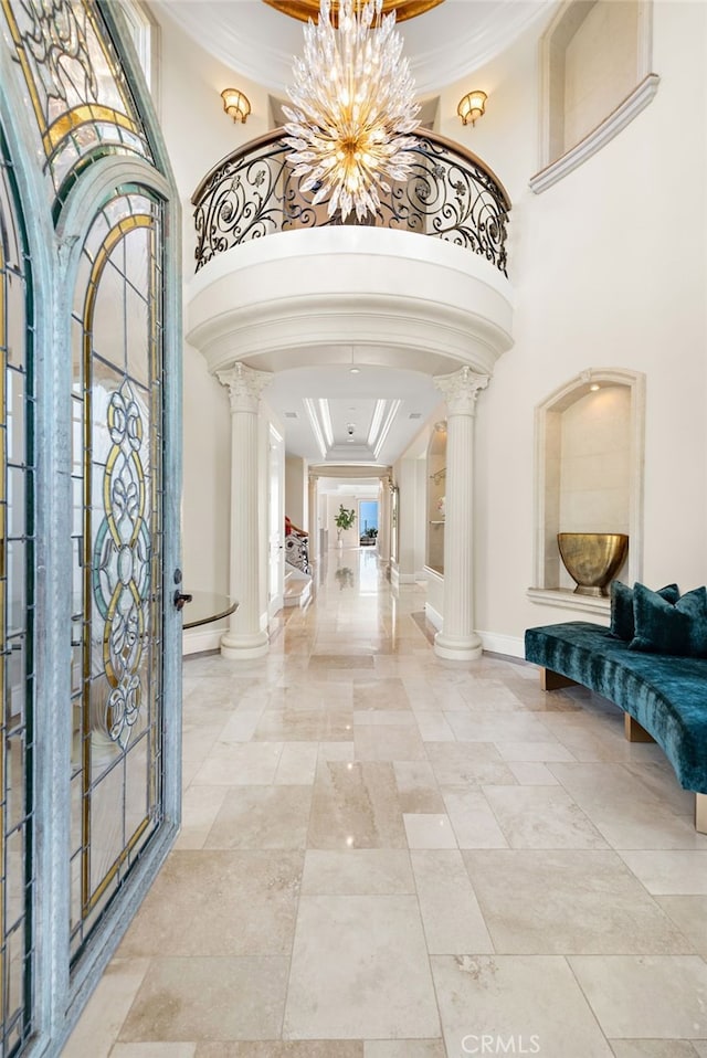 31821 Monarch Crst, Laguna Niguel, CA 92677 - entrance foyer featuring ornate columns, arched walkways, ornamental molding, a tray ceiling, and a towering ceiling