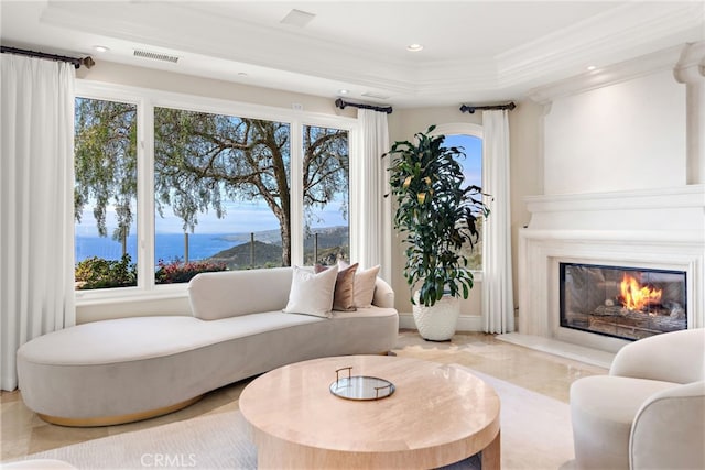 31821 Monarch Crst, Laguna Niguel, CA 92677 - living area with visible vents, crown molding, a raised ceiling, a water view, and a premium fireplace