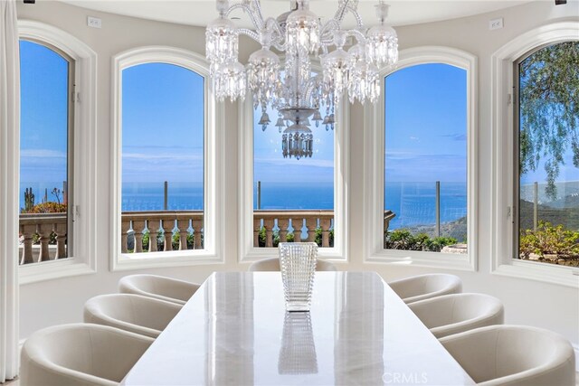 31821 Monarch Crst, Laguna Niguel, CA 92677 - dining room featuring a water view, a wealth of natural light, and a notable chandelier