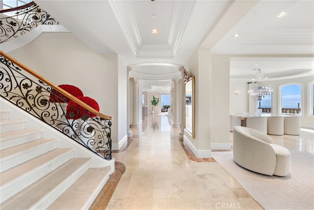 31821 Monarch Crst, Laguna Niguel, CA 92677 - entryway with a raised ceiling, decorative columns, crown molding, recessed lighting, and a chandelier