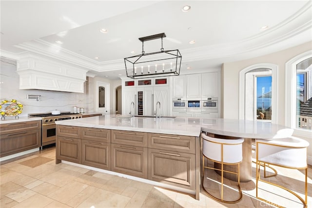 31821 Monarch Crst, Laguna Niguel, CA 92677 - kitchen featuring backsplash, recessed lighting, a tray ceiling, and stainless steel range