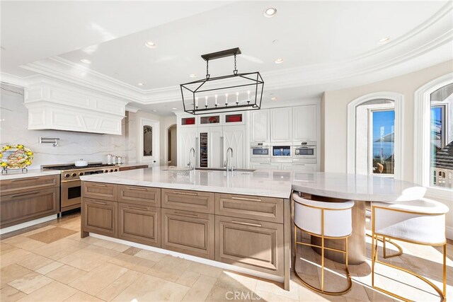 31821 Monarch Crst, Laguna Niguel, CA 92677 - kitchen featuring a tray ceiling, high end range, backsplash, recessed lighting, and oven
