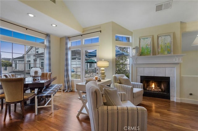 interior space with visible vents, baseboards, wood finished floors, and a fireplace